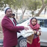 Secretary HAFCT Distributing Old Clothes