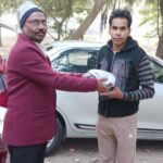 HAFCT Secretary Distributing Old Clothes